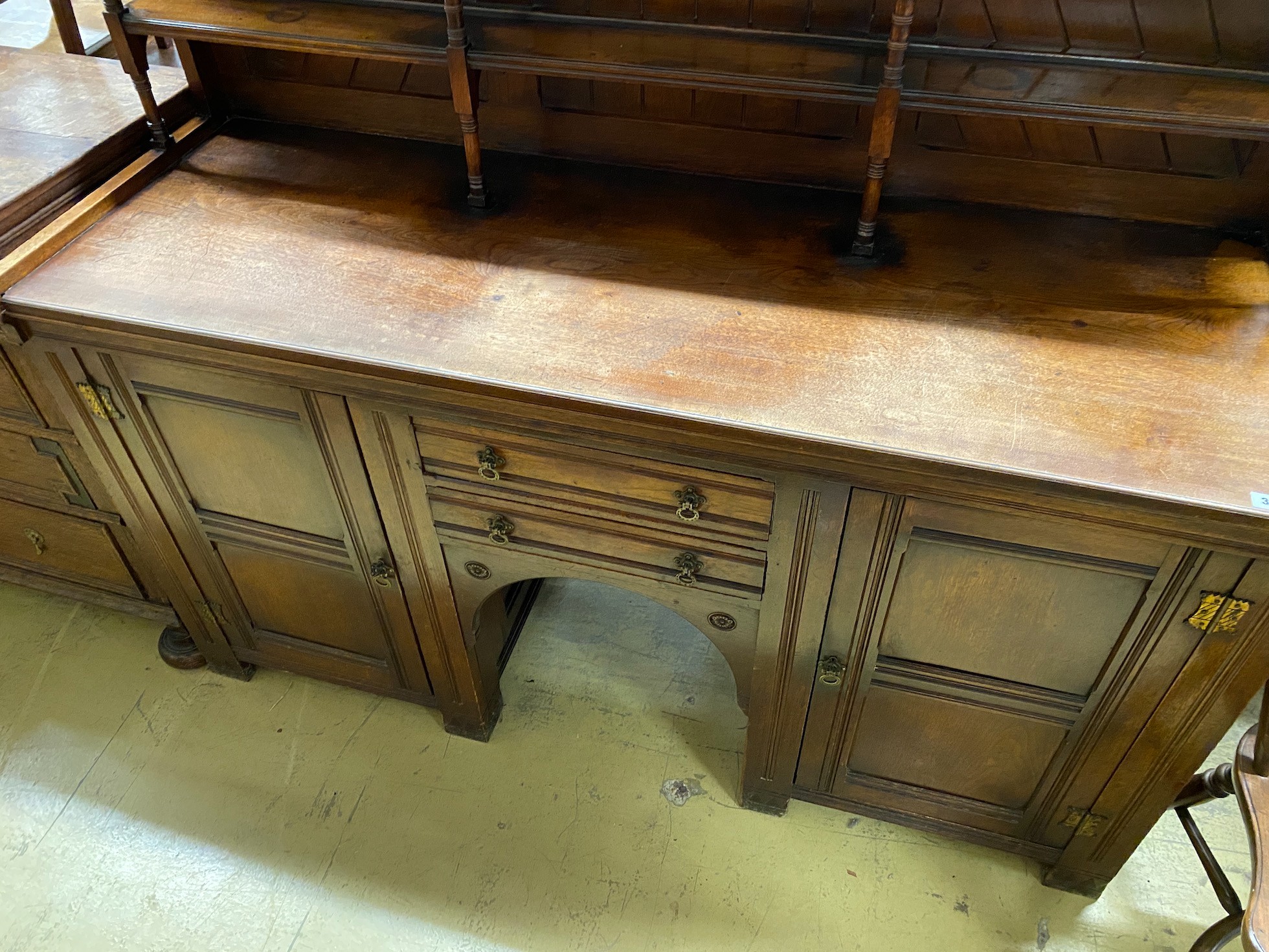 A Victorian aesthetic movement mahogany dresser with Latin motto to the frieze, width 168cm, depth 60cm, height 182cm